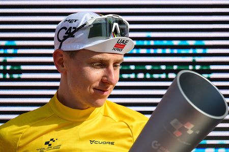 UAE Team Emirates-XRG's Slovenian rider Tadej Pogacar celebrates on the podium with his trophy after winning the Men's Tour of Switzerland (Tour de Suisse) cycling race, in Villars-sur-Ollon on June 21, 2026. (Photo by Harold Cunningham / AFP)