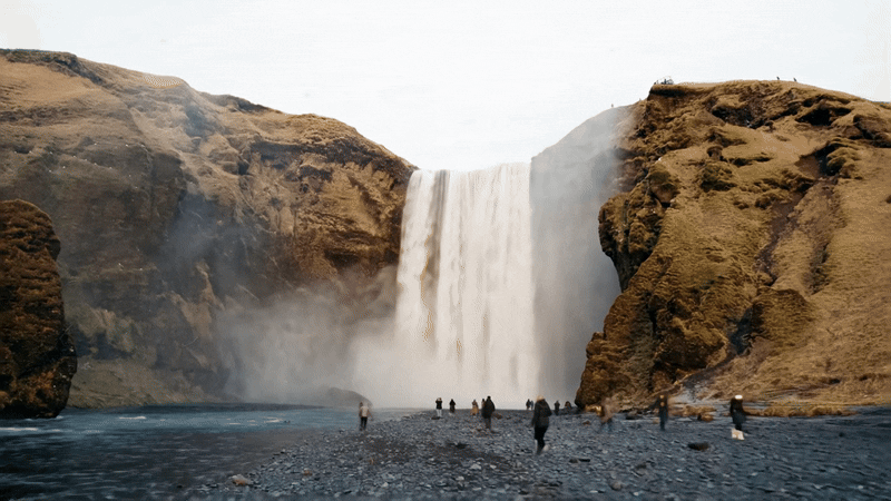 Motion gif of a drone style shot of a waterfall