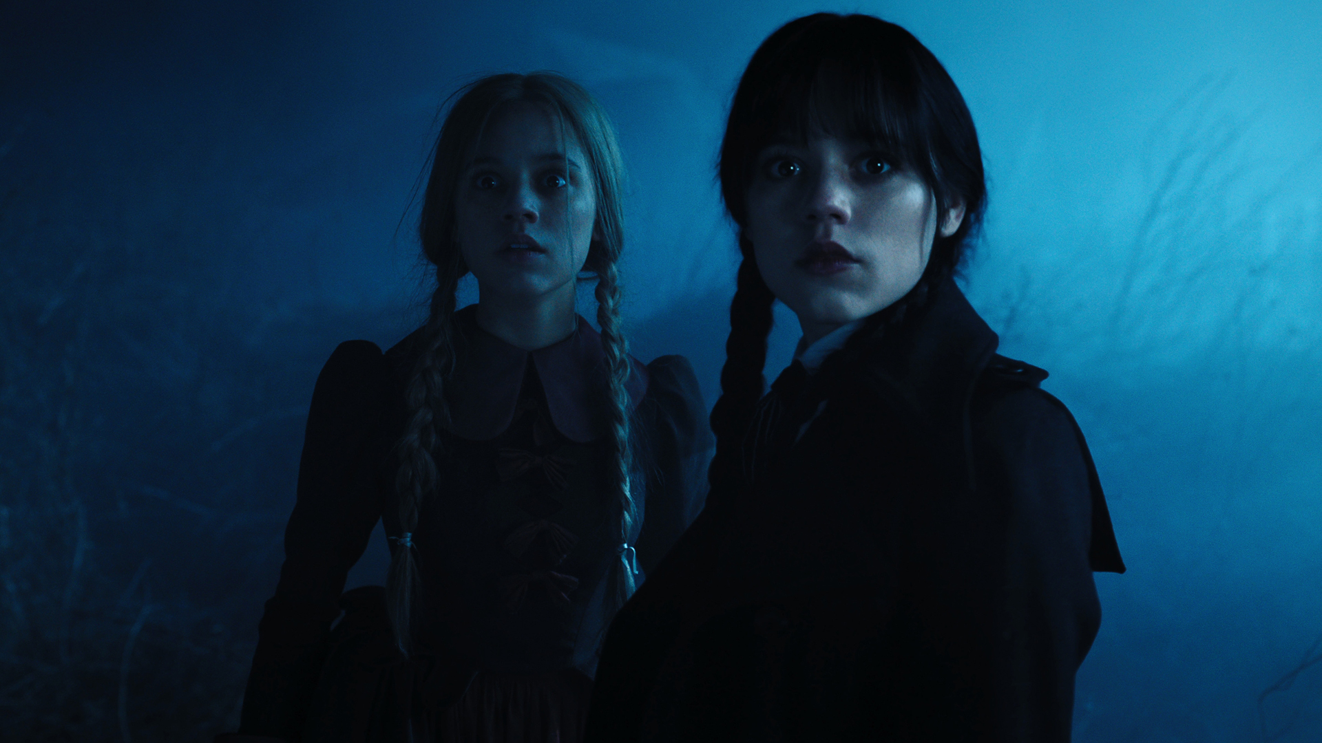 Goody Adams and Wednesday Addams stare at something off-screen in Wednesday season 1