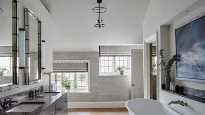 bathroom with tub and large window