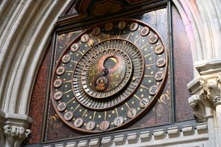 An old ornate clock face with roman numerals