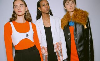 Models wear bright colour t-shirts with black leather and fur coat and black skirt