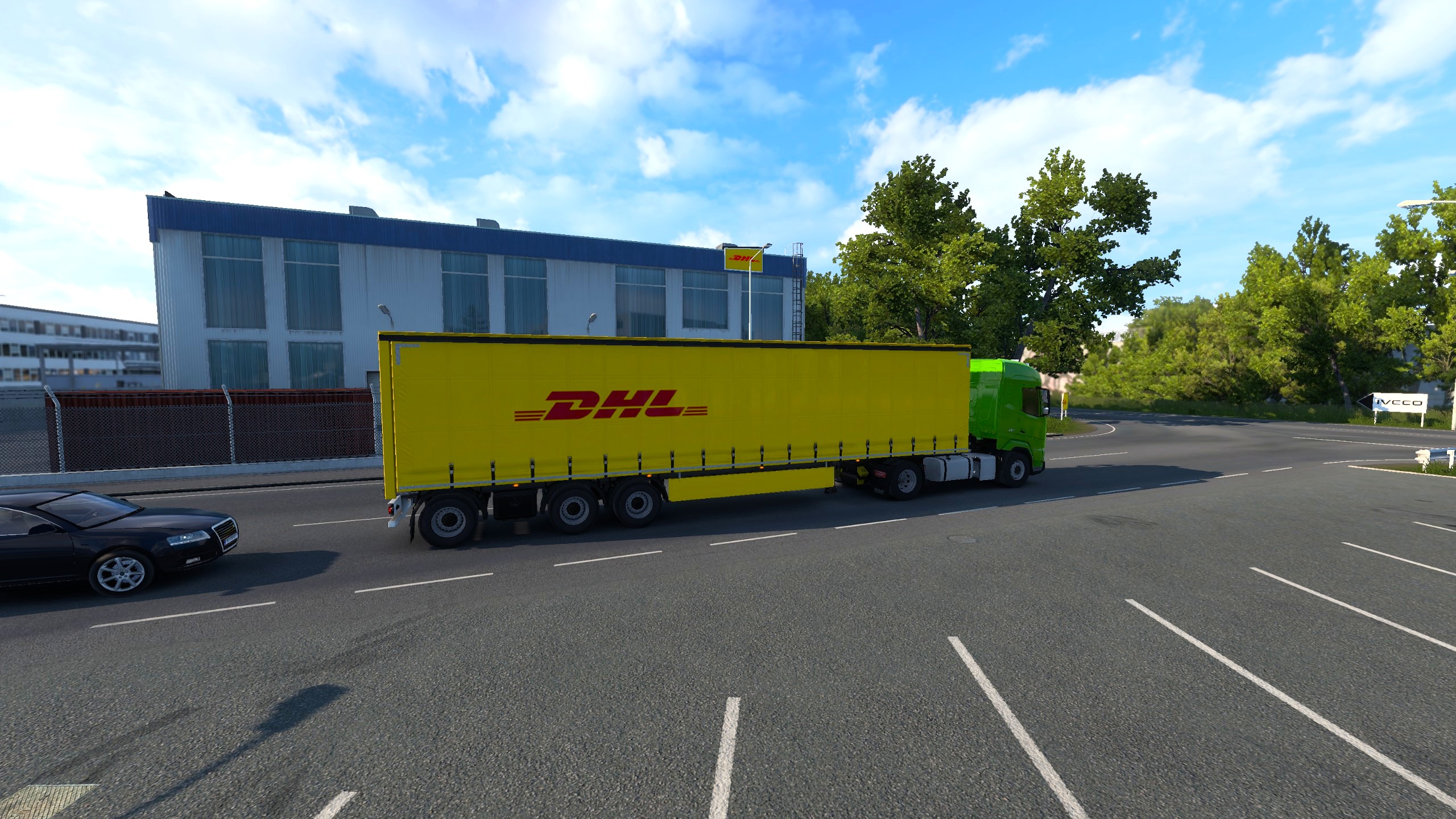 A screenshot from Euro Truck Simulator 2 driving a green DAG XG towing a DLH trailer in front of a DHL depot.