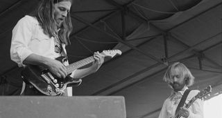 David Gilmour [left] wears a white shirt and jams on his Black Strat live at Hyde Park, with folk legend Roy Harper playing a Les Paul Custom