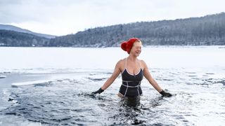 Older woman swimming in winter with a bobble hat