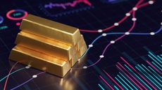Gold bars on financial chart background signifying gold ETFs