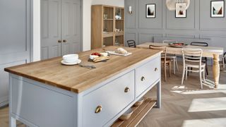pale blue shaker island unit in kitchen with matching wall panelling