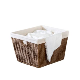 A dark brown wicker basket with fabric lining 