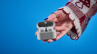 Sony WF-1000XM6 earbuds photographed in front of a blue background