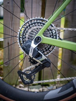 Detail photo of a green Ridley ASTR RS leaning against a wooden fence