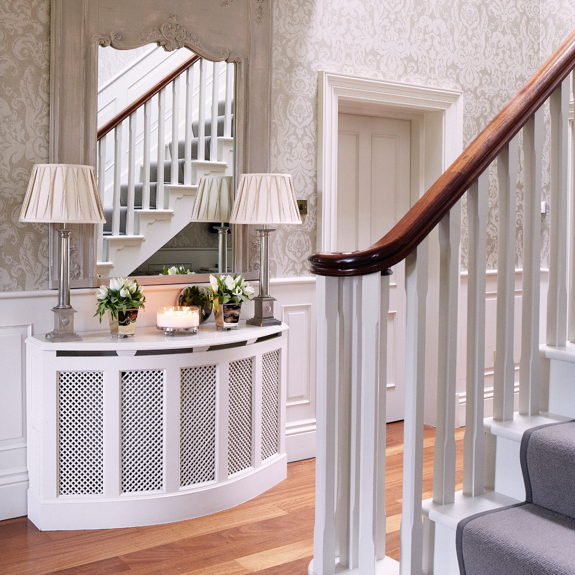 hallway with panelled walls and curved white radiator cover
