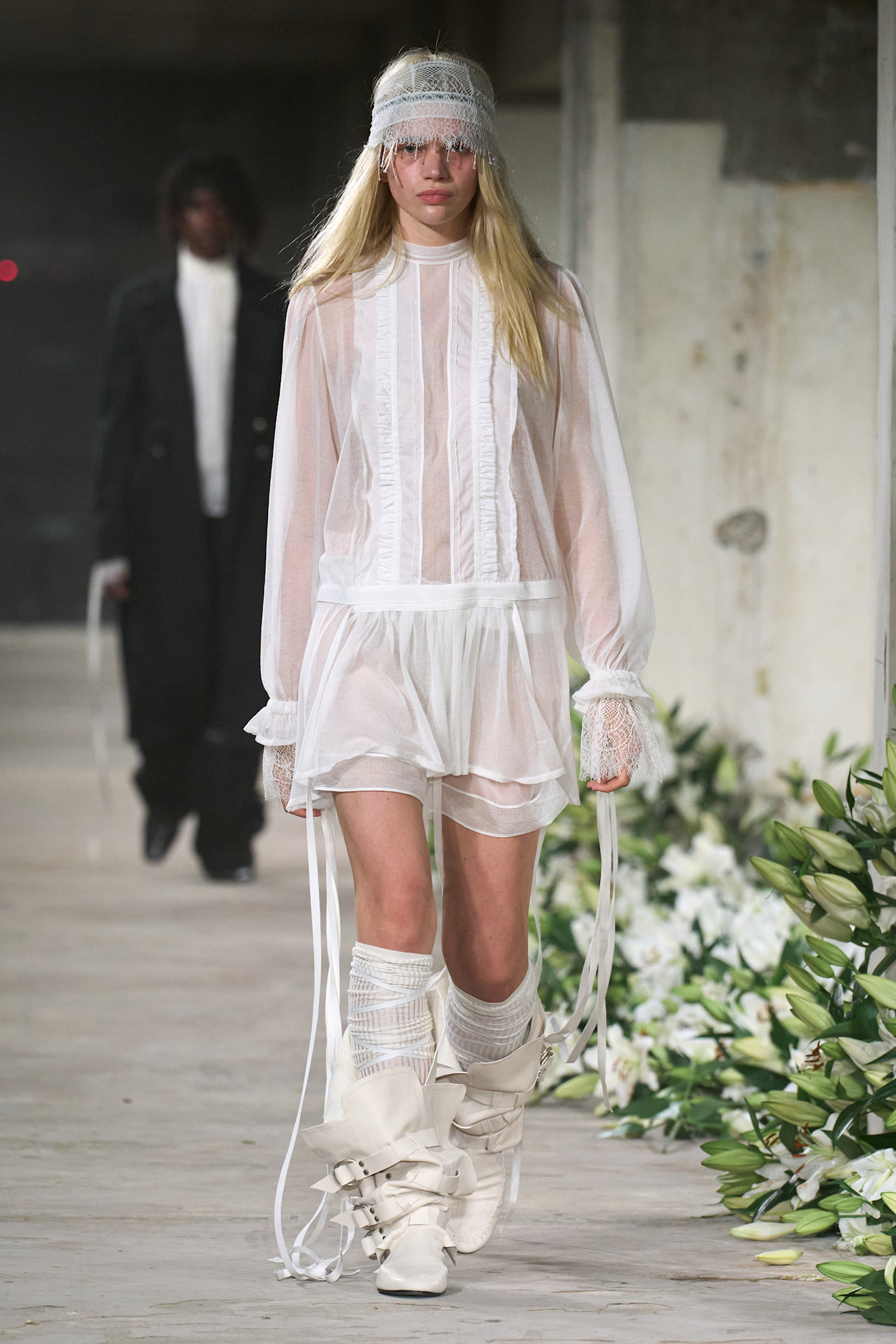 A model wore Lola Tung's sheer white look on the Ann Demeulemeester Spring/Summer 2025 runway.