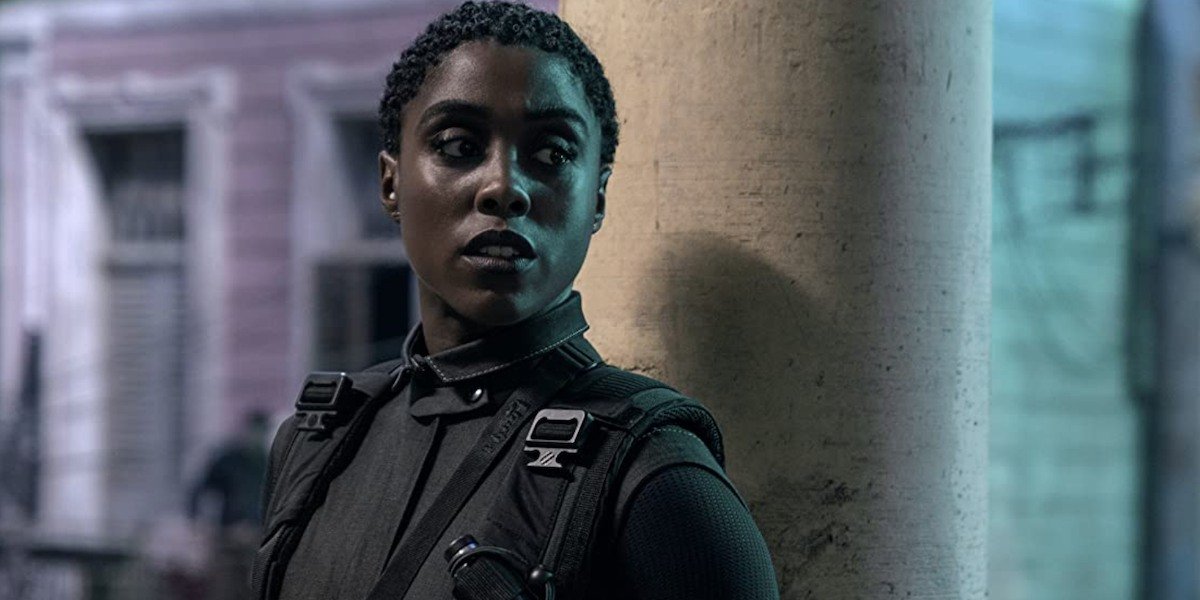 Nomi (Lashana Lynch) stands against a pillar in a scene from &#039;No Time To Die&#039;