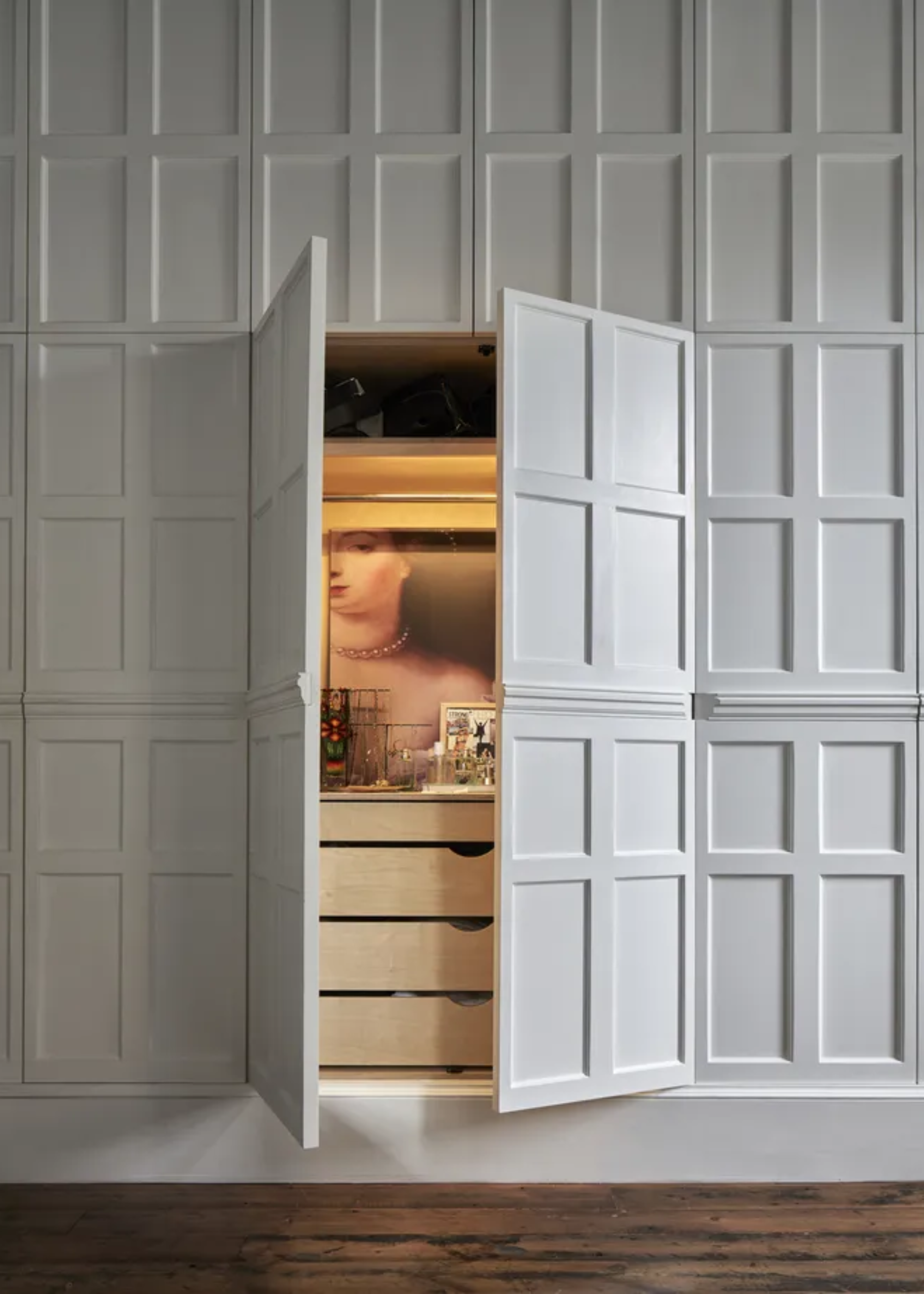 A white wardrobe with closet lighting