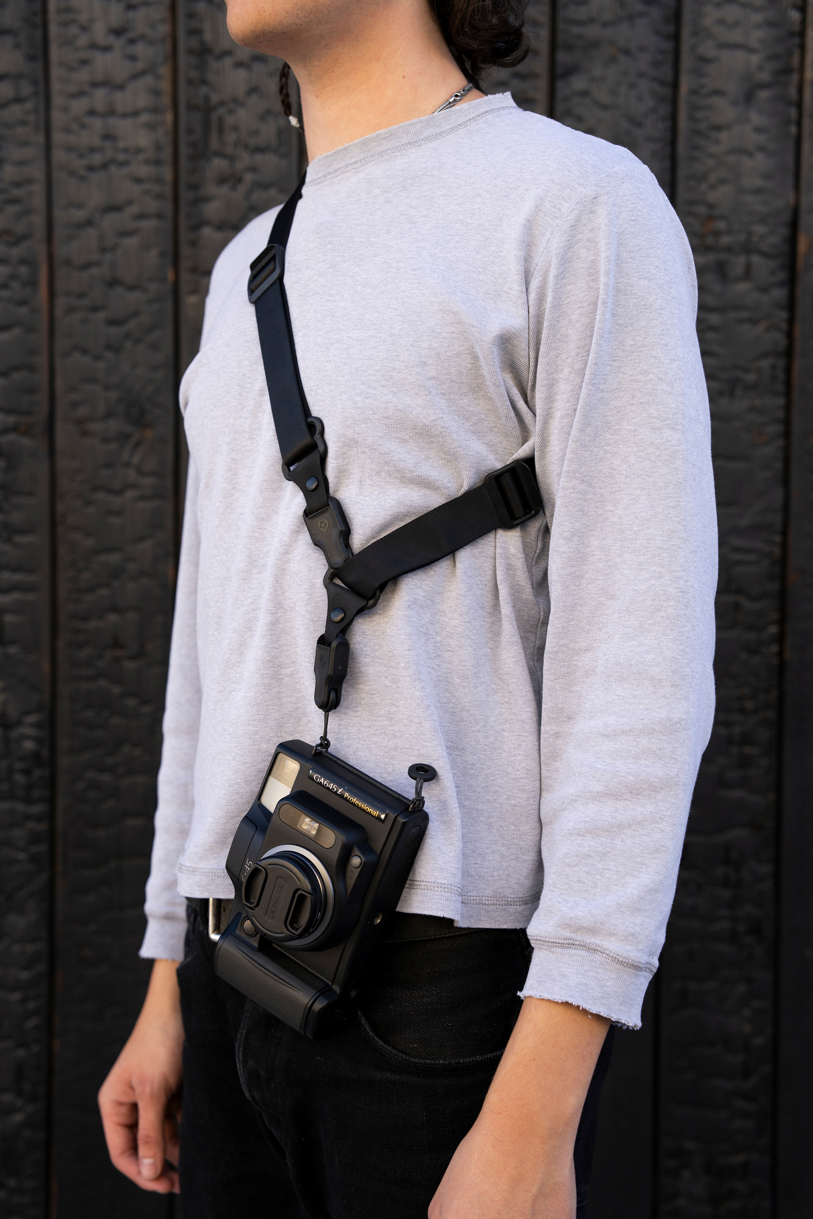 The Wandrd Magnetic Camera strap being used by a photographer
