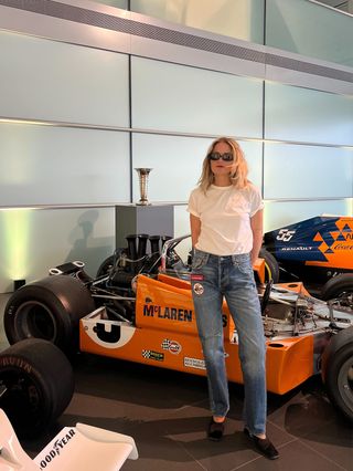 Eliza Huber wearing a white T-shirt and dark wash Levi's x McLaren jeans at the McLaren Technology Center.