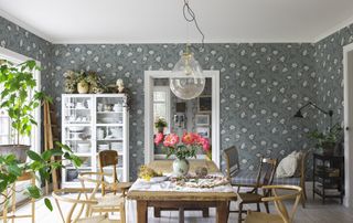 dining room with sandberg wallpaper and glass shaded pendant above the dining table