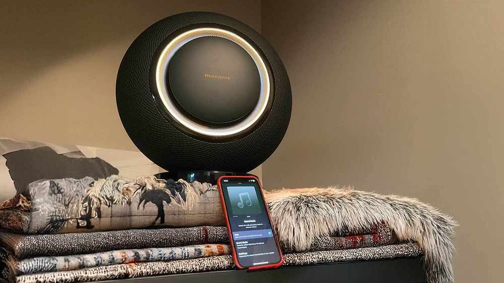 Marantz Horizon sitting on a pile of rugs with a phone in front of it