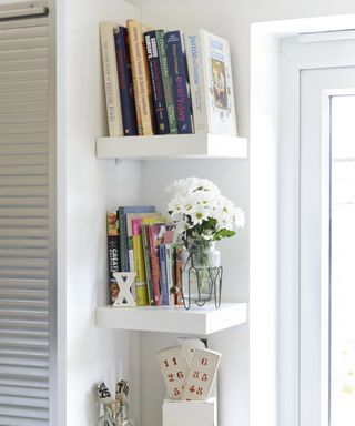 white floating corner shelves in a kitchen with books