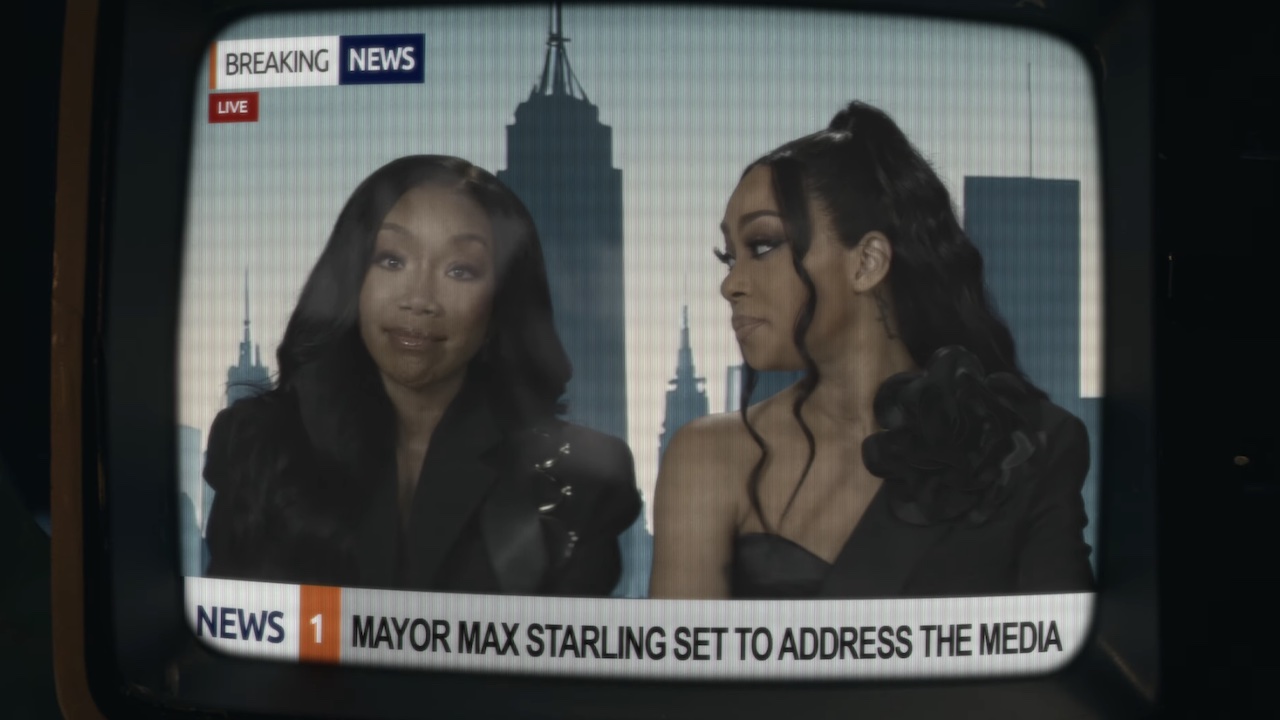 Brandy and Monica as newscasters in Ariana Grande's music video