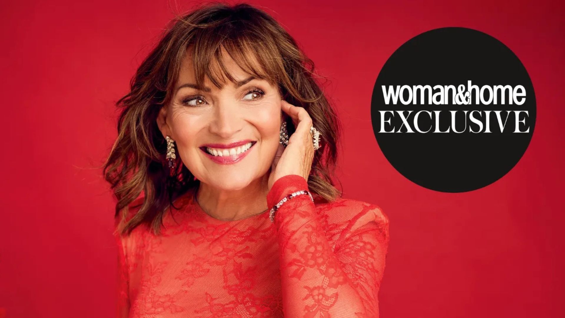 Lorraine Kelly pictured on woman&amp;home's Christmas issue cover, wearing a red lace dress with green smoky eyeliner and a raspberry lip
