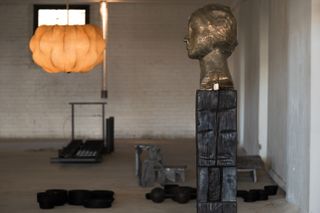 Installation view of Sized featuring Rewire Nuvola Suspension lighting by Tobia Scarpa, and Vanessa Beecroft VB.B.031, 2019, bronze head
