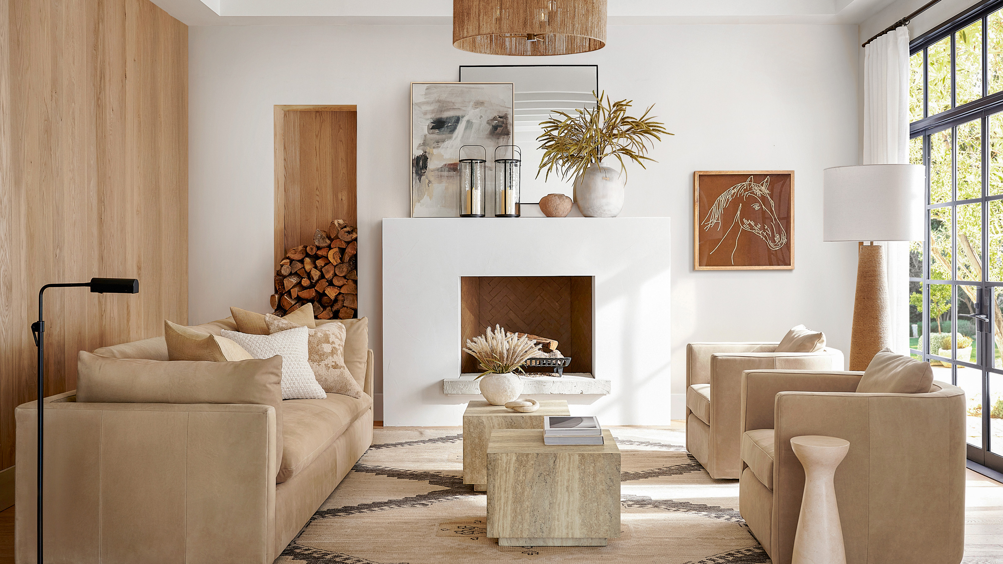 living room with beige sofa and armchairs white walls wooden panelling and neutral decor