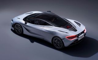 An aerial view of a grey McLaren 720S photographed against a grey background