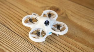 betaFPV Cetus Lite drone on a wooden surface