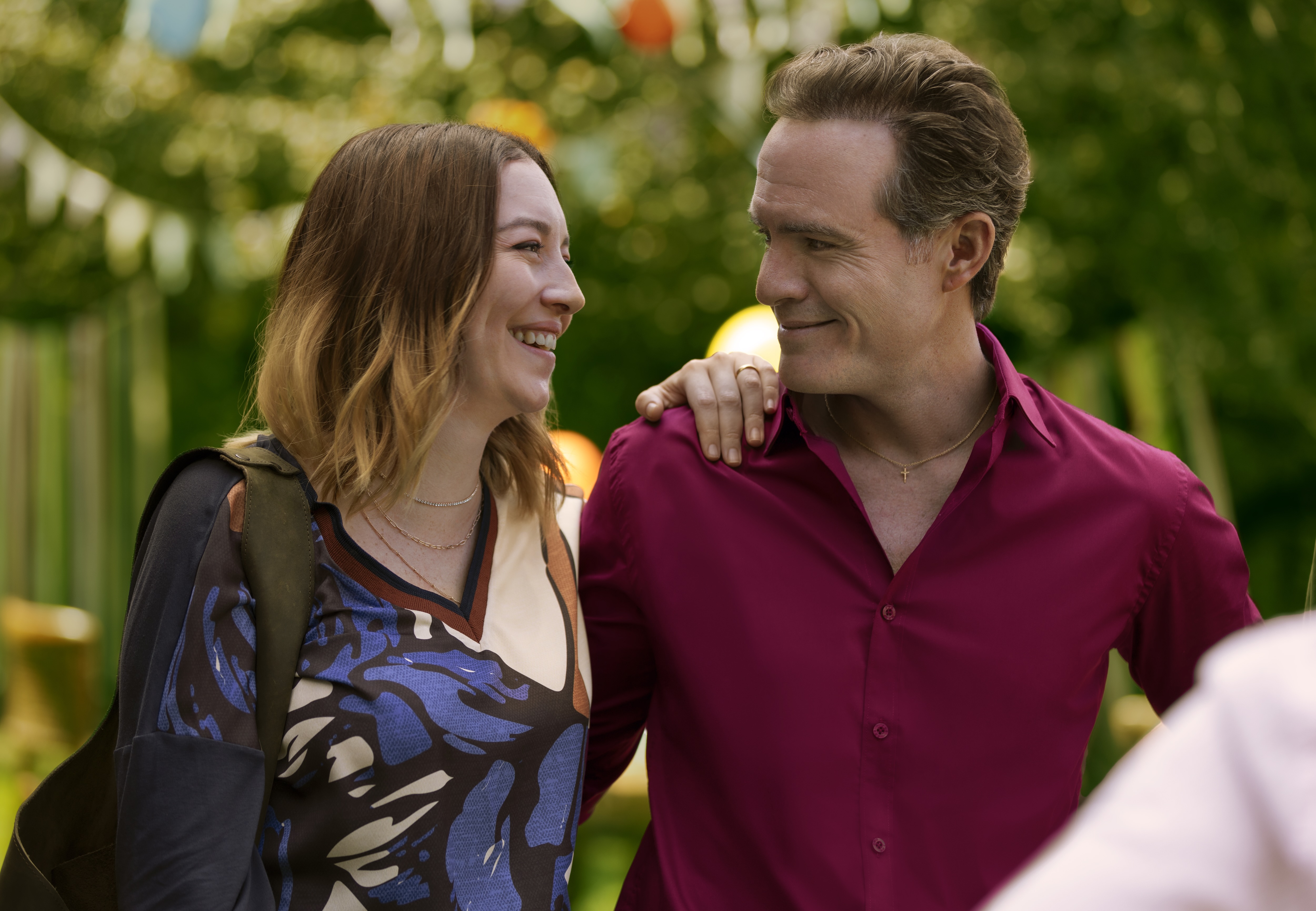 A couple (Regina Bland&amp;oacute;n as Carla, Erik Hayser as David) stand together at an outdoor party, in Netflix&#039;s &#039;The Accident.&#039;