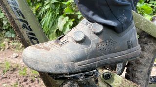 A muddy Fox Union BOA Flat shoe seen from the side