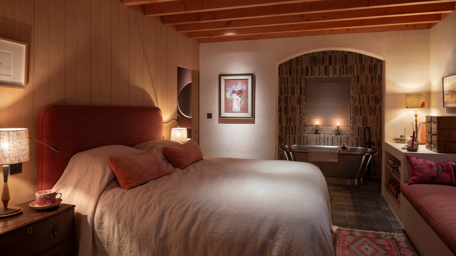neutral bedroom with low lighting from multiple sources