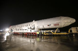 An Antares rocket built by Orbital Sciences Corp. rolls out to its launch pad at NASA's Wallops Flight Facility on Wallops Island, Virginia, on July 10, 2014 ahead of a planned July 13 launch. The mission will launch Orbital's unmanned Cygnus cargo ship t
