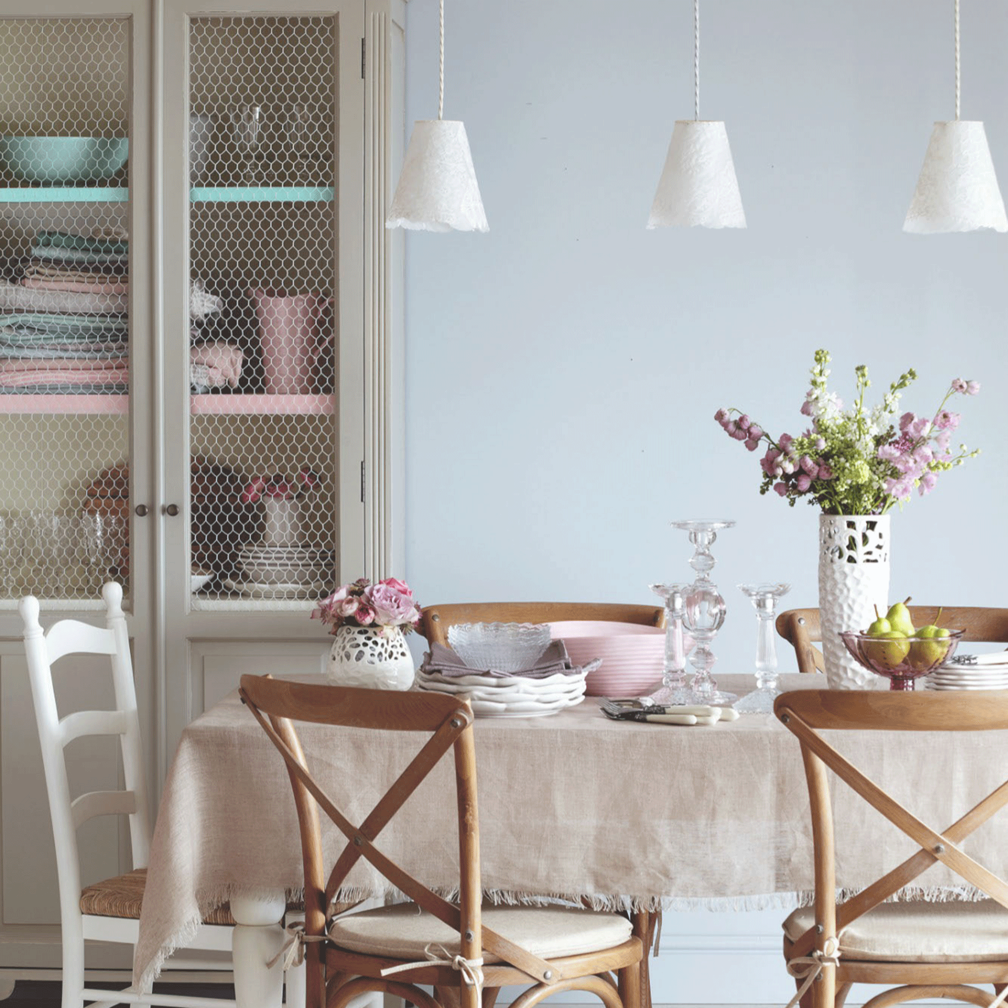 Grey dining room with three pendant lights and table