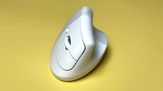 The Logitech Lift for Mac mouse against a yellow background.