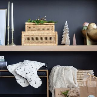 a shelf of neutral christmas decor with a variety of textures from blythe interiors