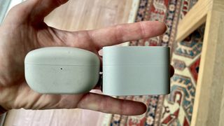 The Sony WF-10000XM6 next to the Sony WF-1000XM5, held in a hand, to show the size difference