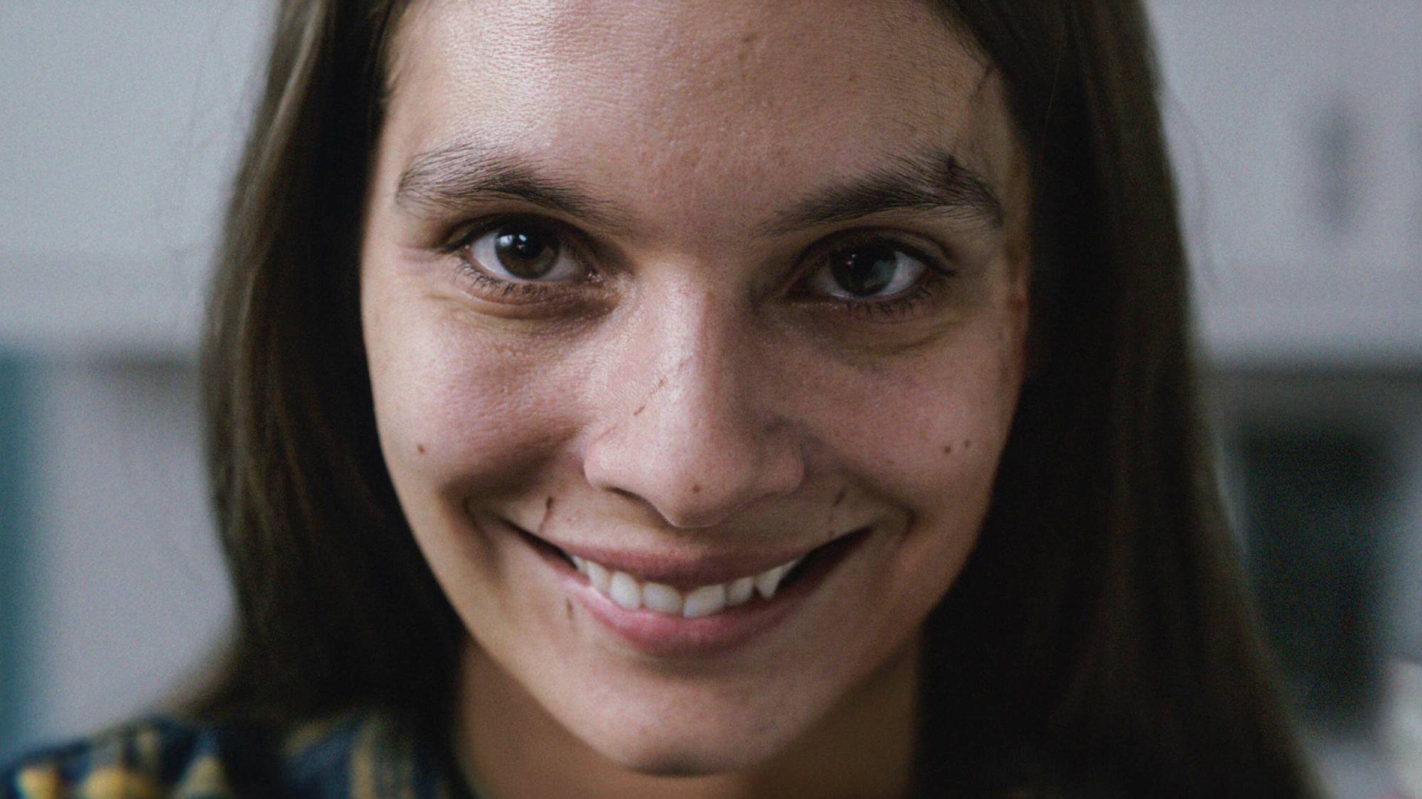 Caitlin Stasey as Laura Weaver in "Smile"