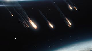 large balls of fire fall from space onto earth below