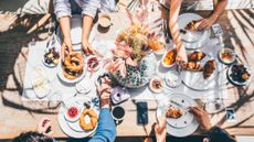 Group of girlfriends having breakfast together on the patio