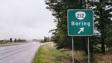 A highway sign points the way to a town called Boring.