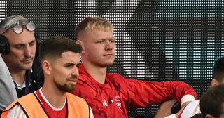 Arsenal goalkeeper Aaron Ramsdale (C) looks on from his place on the bench during the English Premier League football match between Everton and Arsenal at Goodison Park in Liverpool, north west England on September 17, 2023.