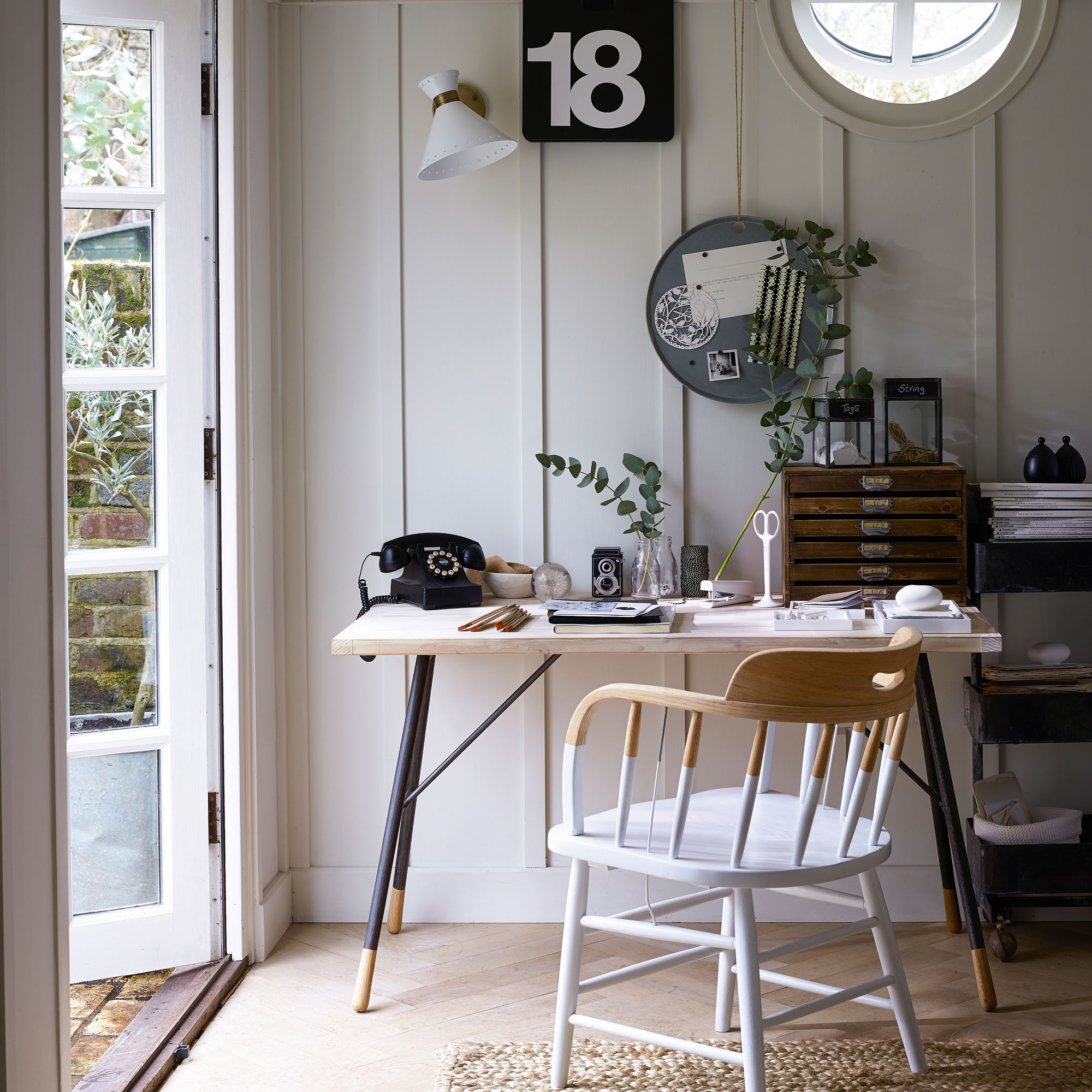 White home office with wooden desk, white and wooden chair