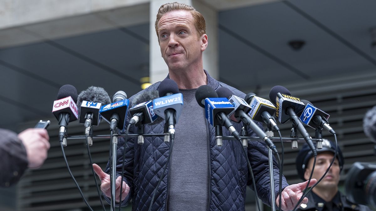 Damian Lewis, star of Billions season 7, gives a press conference surrounded by microphones