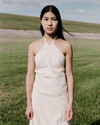 A model wearing a white Baserange top and skirt