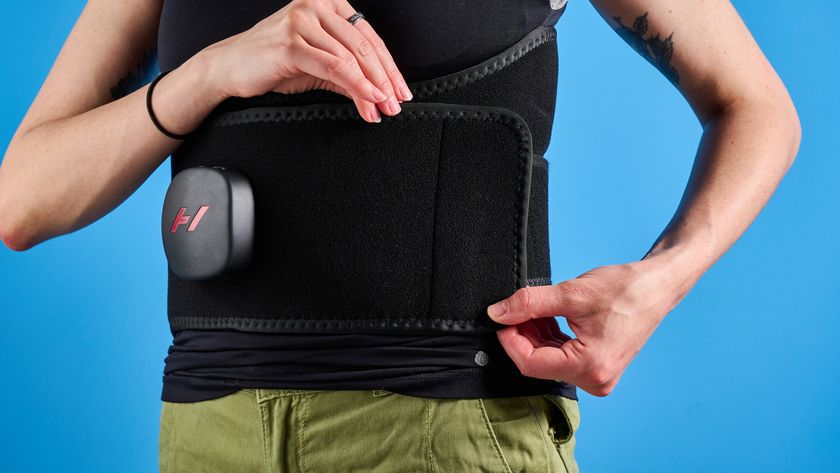 Hyperice Venom 2 Back being worn by a woman photographed in front of a ble background