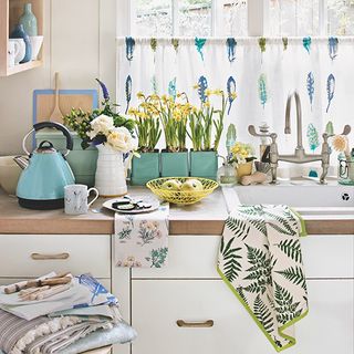 room with cabinet and fern print tea towel