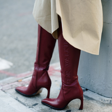 woman wearing burgundy boots in new york