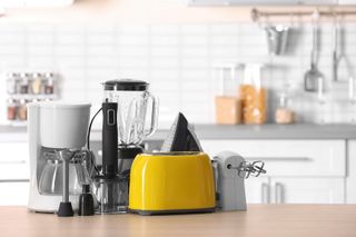 Multiple kitchen appliances grouped together on a kitchen worktop
