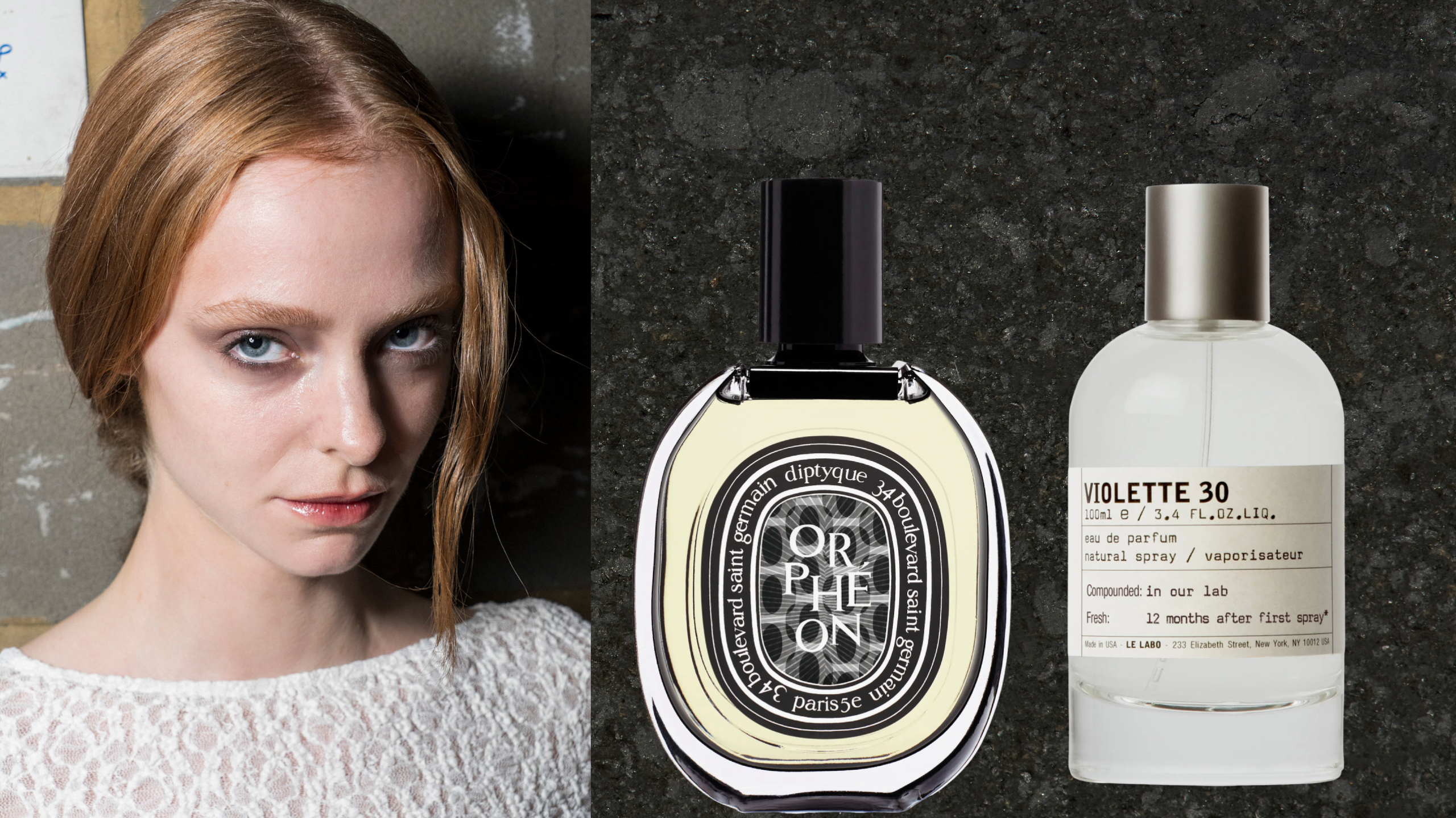 Woman with red hair in a low pony wearing a white lacy shirt. She is next to two bottles of perfume